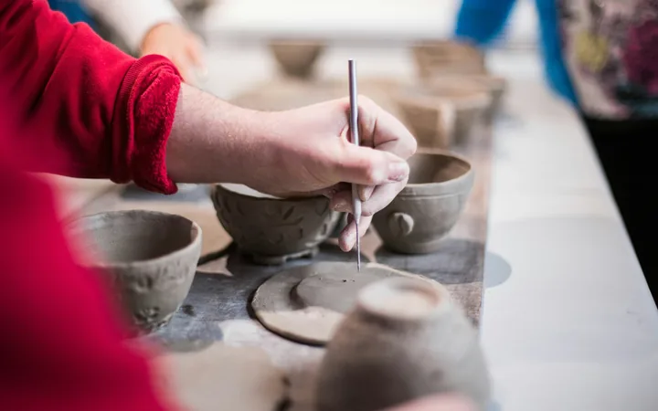 A resident taking part in a pottery activity at Menwinnion