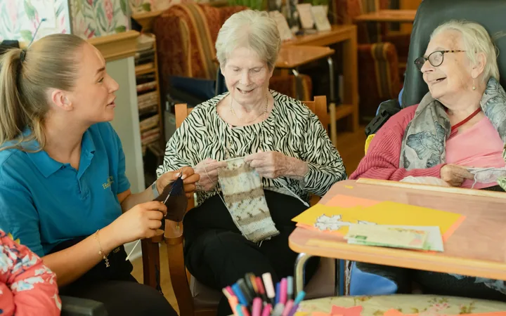 Residents enjoying a knitting activity with a Menwinnion care team member